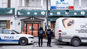 Police are seen outside a convenience store in Montreal, Canada, on March 13, 2026.