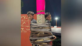 Two young men taped to a lamp post by a vigilante in the Mexican city of Lagos de Moreno for allegedly stealing a motorcycle.