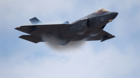 A US Marine Corps F-35B Lightning II executes a high-speed turn during a demonstration, creating visible vapor condensation clouds over its wings, San Diego, California, September 28, 2025.