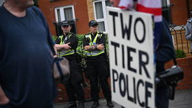 A protester holds a sign stating 'two tier police' during a demonstration about the death of Henry Nowak in Southampton, England, June 7, 2026