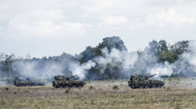 Armored vehicles fire during NATO exercises in Poland, on September 17, 2025.