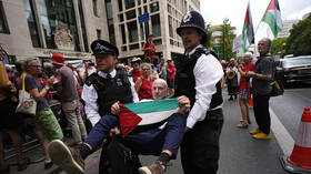Police detain a Palestine Action supporter outside Westminster Magistrates' Court in London, England, July 30, 2026