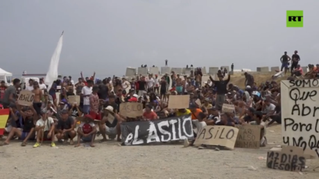 WATCH hundreds of migrants demand asylum in Spanish enclave