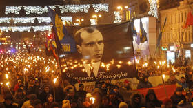 Ukrainian neo-Nazis carry a large banner depicting an OUN leader, Stepan Bandera, during a torchlit march in Kiev, Ukraine, on January 1, 2020.