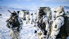 NATO troops stand in the snow during the military exercise "Cold Response 26", on March 15, 2026.