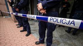 Police officers stand behind a line of police tape in Warsaw, Poland, on September 11, 2026.