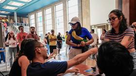 Brazilian voters cast their ballot during general elections at the Lisbon University Campus in Lisbon, Portugal, on October 4, 2026.