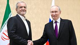 Russian President Vladimir Putin shakes hands with his Iranian counterpart, Masoud Pezeshkian, before a meeting in Turkmenbashi, Turkmenistan, October 8, 2026