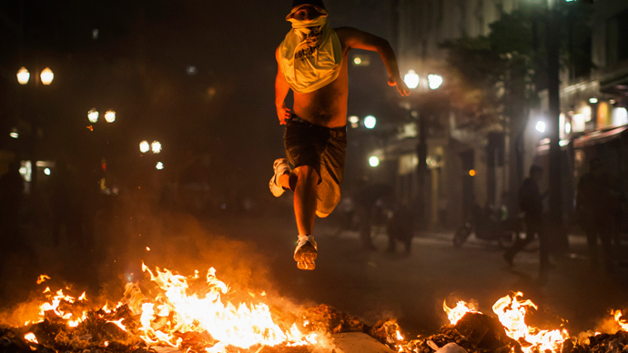 Brazil uprising, Libya in chaos, Assange’s limbo, Syria ‘Rebels,’ RIP Michael Hastings