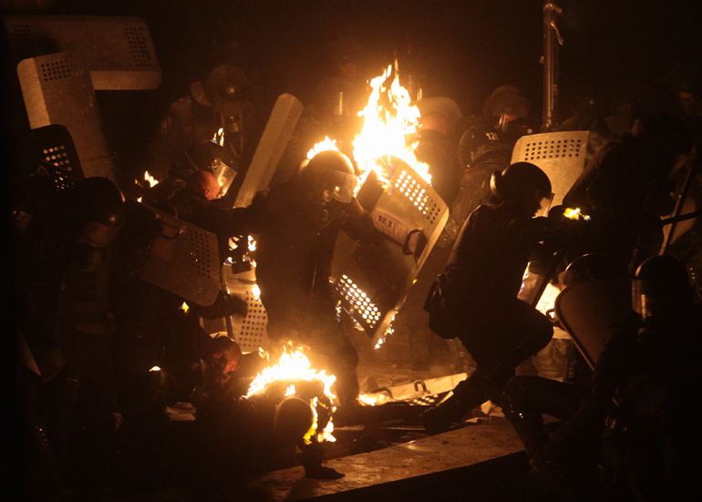 Ukrainian riot police reacts after being hit by a petrol bomb during clashes with pro-European integration protesters in Kiev January 19, 2014. (Reuters / Stringer)