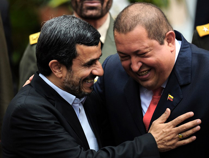Venezuelan President Hugo Chavez and his Iranian counterpart Mahmoud Ahmadinejad, smile at Miraflores presidential palace in Caracas on January 9, 2012. (AFP Photo / Juan Barreto)