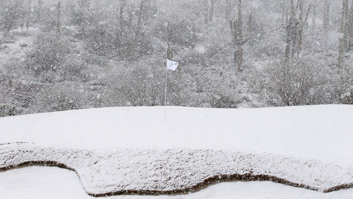 The 18th green is covered in snow as play was suspended during the first round of the WGC-Accenture Match Play Championship golf tournament in Marana, Arizona February 20, 2013 (Reuters / Matt Sullivan) 