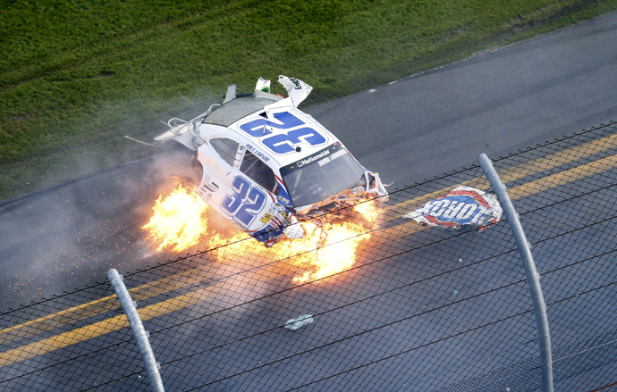 NASCAR driver Kyle Larson's Chevrolet slides on fire down the front stretch on the final lap. (Reuters)