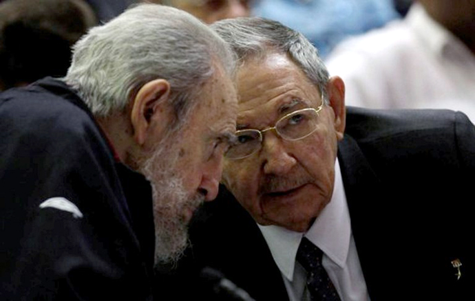 Cuban leader and former president Fidel Castro (L) listening to his brother and current president, Raul, as Cuba's new National Assembly meets to choose a Council of State, at the Conventions Palace in Havana on February 24, 2013. (AFP Photo / Ismael Francisco)