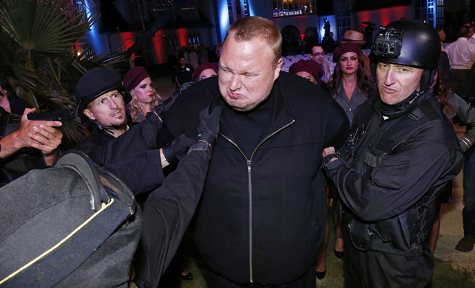 Actors in police costume mock-arrest Megaupload founder Kim Dotcom, as he launches his new file sharing site 'Mega' in Auckland January 20, 2013. (Reuters / Nigel Marple)