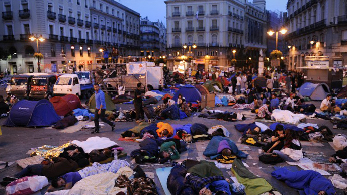 Protesters rest in their sleeping bags at the Puerta del Sol square in Madrid on May 22, 2011 during a protest against Spain's economic crisis and its sky-high jobless rate. (AFP Photo / Pedro Armestre)