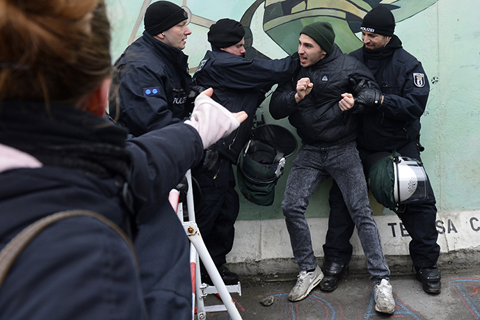Police arrest an activist during a protest against the removal of a section of the East Side Gallery. (AFP Photo / Odd Andersen)