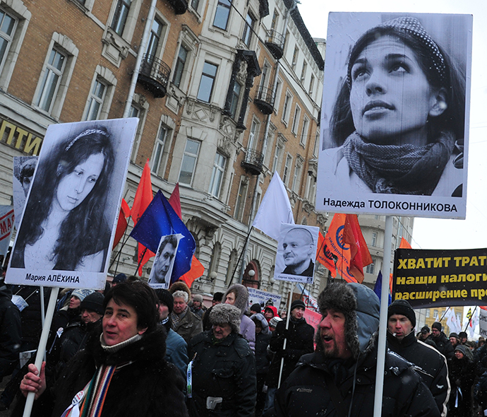 The boards display portraits of jailed members of the female punk band "Pussy Riot" Maria Alyokhina and Nadezhda Tolokonnikova. (RIA Novosti / Alexei Kudenko)