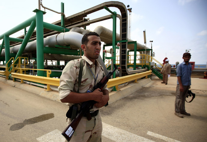 An anti-Gaddafi fighter stands guard at the Mellitah Oil and Gas complex during a handover ceremony in Mellitah, 80 km west Tripoli September 6, 2011. (Reuters/Zohra Bensemra)