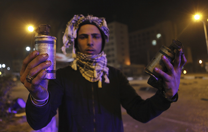 A protester, who opposes Egyptian President Mohamed Mursi, shows empty teargas canisters during clashes with riot police in front of Security Directorate of Port Said after protesters started to set fire to it in Port Said city, 170 km (106 miles) northeast of Cairo March 5, 2013. (Reuters / Amr Dalsh)