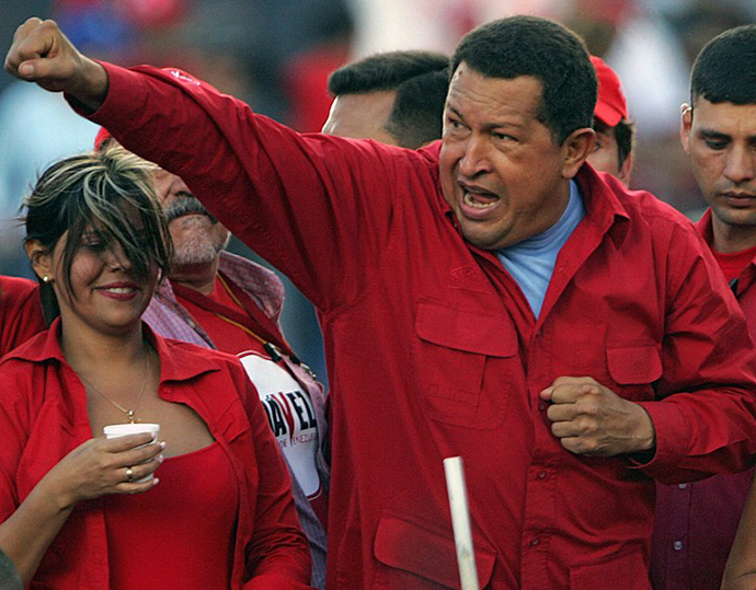 This file picture shows Venezuelan President and reelection candidate Hugo Chavez gesturing to supporters during a campaign rally at "Petare" shantytown in Caracas on November 1, 2006. (AFP Photo / Juan Barreto)