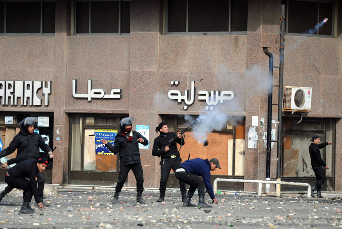  A member of the Egyptian riot police shoots tear gas at protesters during clashes in the Suez Canal city of Port Said on March 7, 2013. (AFP Photo/Jonathan Rashad)
