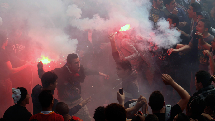 Egyptian al-Ahly football club supporters (Ultras) light flares as they celebrate in Cairo on March 9, 2013 (AFP Photo / Mahmud Khaled)