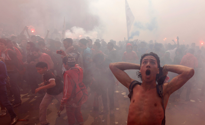 Al-Ahly fans, also known as "Ultras", celebrate and shout slogans in front of the Al-Ahly club after hearing the final verdict of the 2012 Port Said massacre in Cairo March 9, 2013 (Reuters / Amr Abdallah Dalsh)