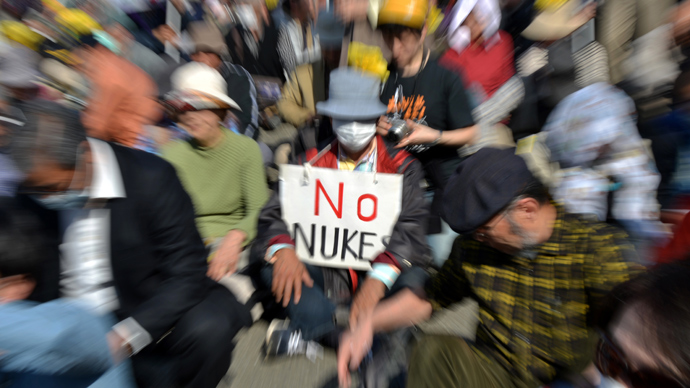 A protestor (C) holds a placard that reads 'No Nukes' at an anti nuclear rally in Tokyo on March 9, 2013 (AFP Photo / Yoshikazu Tsuno)