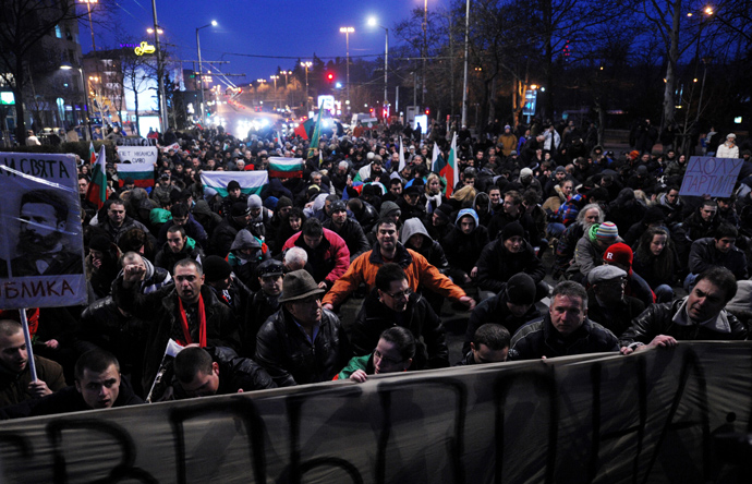 Demonstrators sit in silence while listening to Bulgaria national anthem during a protest against high electricity bills in Sofia on February 20,2013 (AFP Photo / Nikolay Doychinov)