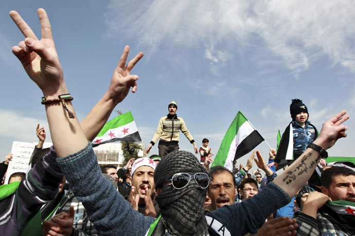 A Syrian living in Jordan flashes the victory sign during a protest against Syrian President Bashar Al-Assad in front of the Syrian Embassy in Amman February 8, 2013. (Reuters/Muhammad Hamed)