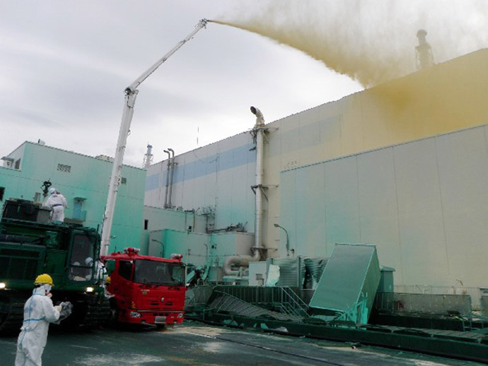 This handout photo taken by Tokyo Electric Power Co (TEPCO) on May 27, 2011 and released on May 29, 2011 shows workers spraying a dust inhibitor into buildings at TEPCO's Fukushima Dai-ichi nuclear power plant at Okuma town in Fukushima prefecture. (AFP Photo/TEPCO)