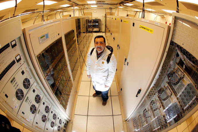 Correlator technician Juan Carlos Gatica with one of the most powerful supercomputers in the world, installed at an altitude of 5,000 meters in Chile's Andes Mountains. Credit: ALMA (ESO/NAOJ/NRAO), C. Padilla 