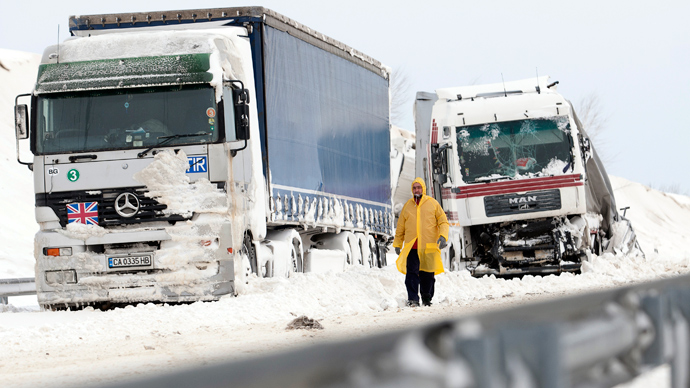 A man walks past a damaged truck at the site of an accident on the E71 motorway, nearby the Croatian, Slovenian and Hungarian borders (AFP Photo / Szilard Gergely)
