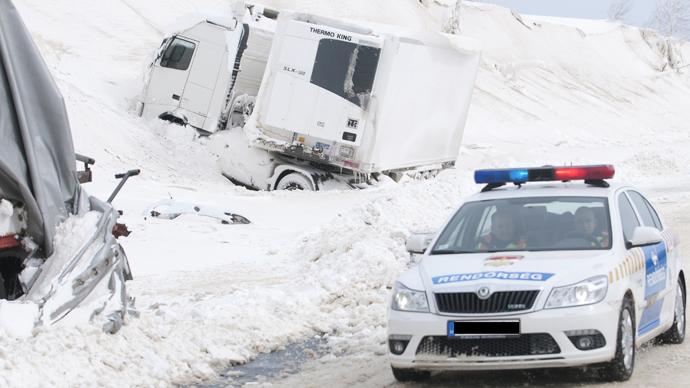  A police car arrives at the site of an accident involving a truck and cars at the E71 motorway, nearby the Croatian, Slovenian and Hungarian borders on March 15, 2013 a day after a heavy snow storm hit the area (AFP Photo / Szilard Gergely)