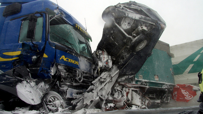 A handout photo released by the Hungarian rescuers Katasztrofavedelem shows destroyed cars and trucks stucked after an accident on the E75 motorway, near Szabadbattyan about 70 km west from Hungarian capital Budapest on March 14, 2013 as thirty cars, eight vans and nine trucks collided after a heavy snow storm hit the area (AFP Photo / Katasztrofavedelem)