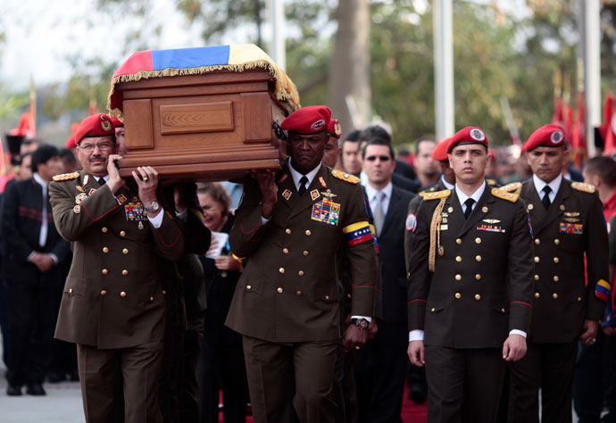 Handout picture released by the Venezuelan presidency showing members of the presidential Honour Guard carrying the coffin with the remains of late Venezuelan President Hugo Chavez as it arrives at a temporary resting place at the former "4 de Febrero" barracks -- a barracks-turned-museum that the former paratrooper had used as his headquarters during a failed 1992 coup attempt -- in Caracas, on March 15, 2013.(AFP Photo / Presidencia)