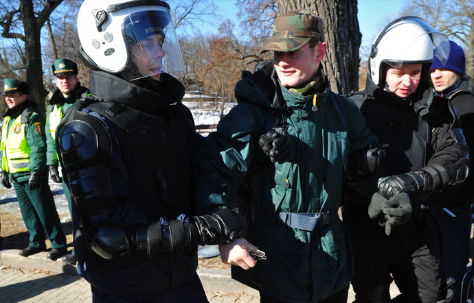 Police officers arrest a man during the Latvian Legionnaire Remembrance Day, a force that was commanded by the German Nazi Waffen SS, as they commemorate a key 1944 battle on March 16, 2013.(AFP Photo / Ilmars Znotins)