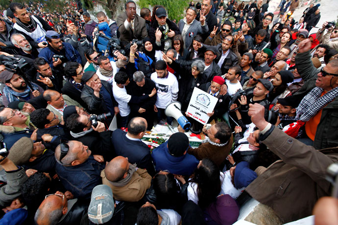Basma, the widow, and the family of assassinated secular opposition leader Chokri Belaid, gather at his tomb to mark the 40th day of mourning after his death in Tunis March 16, 2013.(Reuters / Anis Mili)