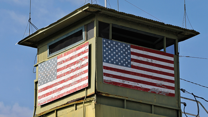 Two members of the US Navy standing in the hallway in Cell Block C in the "Camp Five" detention facility of the Joint Detention Group at the US Naval Station in Guantanamo Bay, Cuba, January 19, 2012 (AFP Photo / Jim Watson)