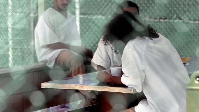 In this photo reviewed by US military officials, detainees, whose names, nationalities, and facial identifications are not permitted, sit within the grounds of Camp Delta 4 military-run prison, at the Guantanamo Bay U.S. Naval Base, Cuba (Reuters / Brennan Linsley / Pool) 