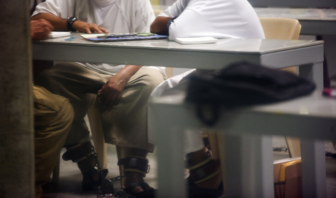 Two detainees shackled to the floor during recreation time in Cell Block A in the "Camp Six" detention facility of the Joint Detention Group at the US Naval Station in Guantanamo Bay, Cuba, January 19, 2012 (AFP Photo / Jim Watson)