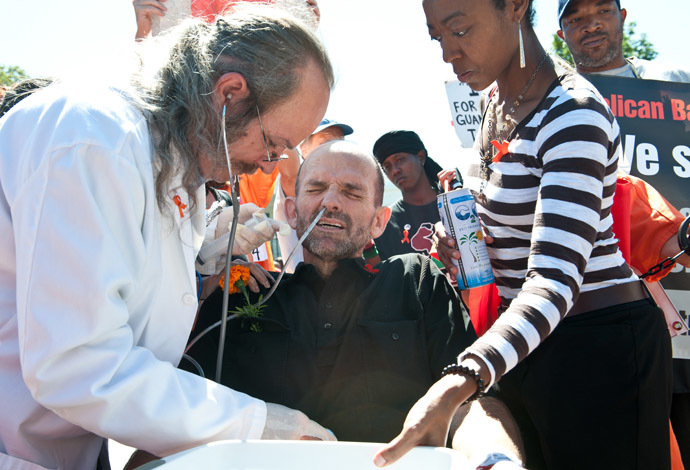 Protester AndrÃ©s Thomas Conteris (C) is force-fed by Dr. Terry Fitzgerald (L) during a demonstration in solidarity with hunger-striking inmates at the US prison at Guantanamo Bay, in front of the White House in Washington on September 6, 2013. (AFP Photo/Nicolas Kamm)