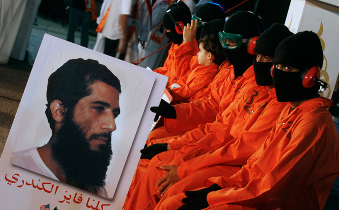 Protesters dressed in orange prison outfits and black masks attend a demonstration outside the US embassy in Kuwait City, calling for the release of Kuwaiti prisoners still behind the bars at the US detention camp in Guantanamo Bay (AFP Photo / Yasser Al-Zayyat)
