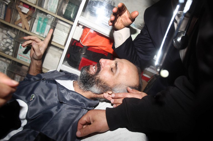 Ayman Sharawna, a Palestinian prisoner who was on long-term hunger strike, is pictured inside an ambulance upon his arrival at al-Shifa hospital in Gaza City on March 17, 2013. (AFP Photo / Mahmud Hams)