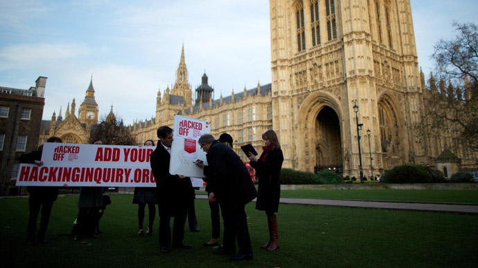 Members of the Hacked Off Campaign stage a photocall to illustrate how many people have signed the petition for a free but accountable press in the United Kingdom out side of Parliament in London on December 3, 2012. (AFP Photo/Andrew Cowie)