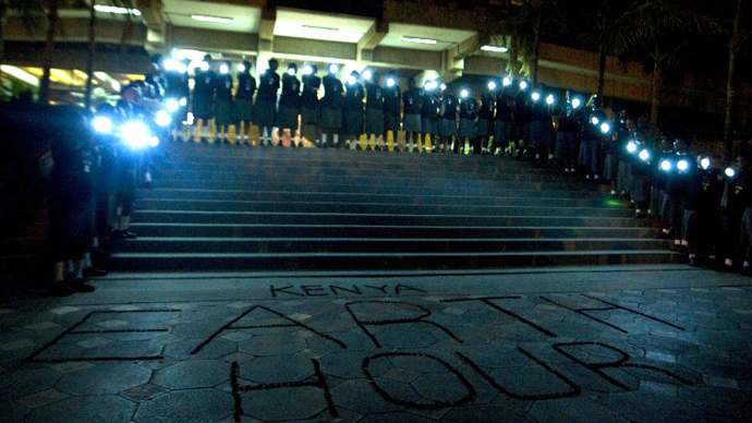 Participants illuminate a sign made with bottle caps and reading 'Kenya Earth Hour' with solar-powered LED lights in Nairobi during the annual Earth Hour campaign on March 31, 2012. (AFP Photo / Tony Karumba)