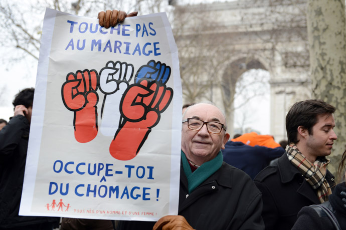 A man holds a placard reading"Don't touch marriage, take care of unemployment" as thousands of people demonstrate against France's gay marriage law in an attempt to block legislation that will allow homosexual couples to marry and adopt children, on March 24, 2013 in Paris. (AFP Photo/Eric Feferberg)