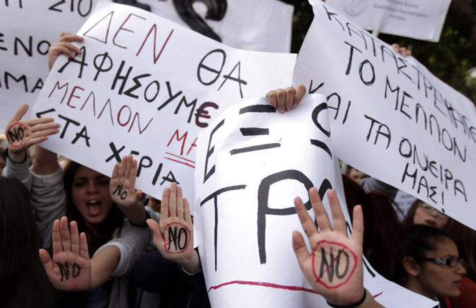 Cypriot college students shout slogans while showing their palms reading "No" during a protest in Nicosia against a bailout for the financially crippled island on March 26, 2013. (AFP Photo / Patrick Baz)