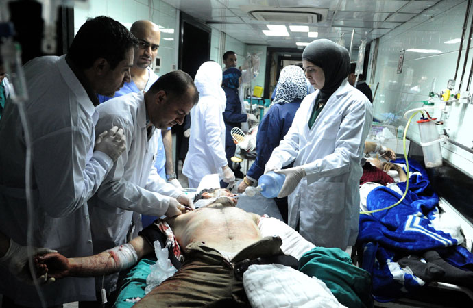 A handout picture released by the Syrian Arab News Agency (SANA) shows an injured people being treated in the emergency room of a hospital following an alleged mortar attack that hit the Baramkeh district of Damascus on March 26, 2013.(AFP Photo / SANA)